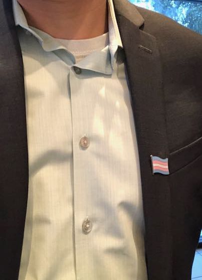 Photo of Peter's lapel with a transgender flag lapel pin