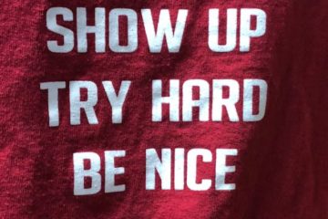 Tee shirt saying "show up, try hard, be nice"