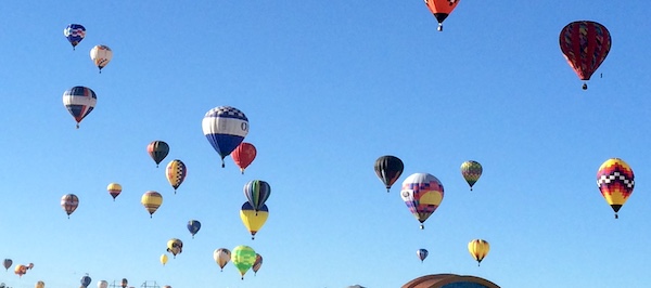 A wide range of hot air balloons rising into the sky as a metaphor for the benefits of life and wellness coaching