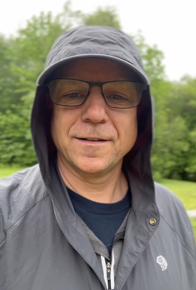 Peter in a raincoat, prepared for bad weather in 2023, on a day clouded by gentle but pleasant rain