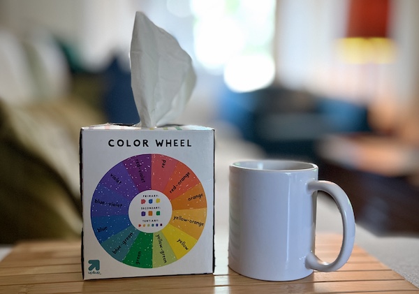 A box of tissues sits on a table next to a white mug, with a blurred background. The tissues are one of many tools of resilience we all keep handy.