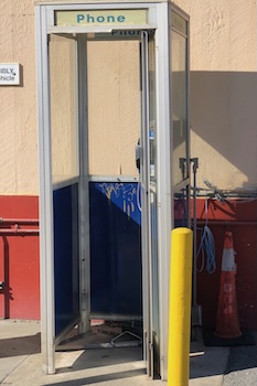 An old style pay phone booth, which can allow people to stay in touch.