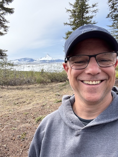 Peter in a selfie along Oregon route 126 with Mt. Washington in the distant background, for the blog about leading with purpose
