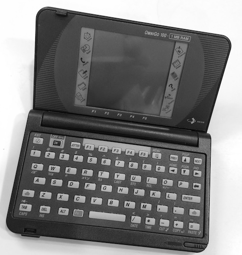 An OmniGo 100 opened up to show the keyboard and screen.