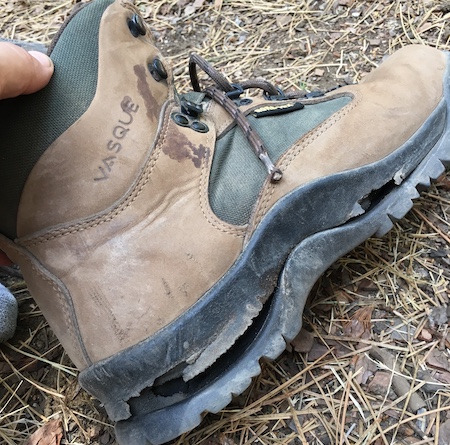 A hiking boot with the sole sheering away from the boot. Unlikely to be caused by a pebble in your shoe, but impossible to walk in just the same.