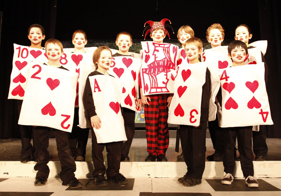 School kids in the play Alice in Wonderland, dressed as playing cards. January 27th is Rabbit Hole Day.