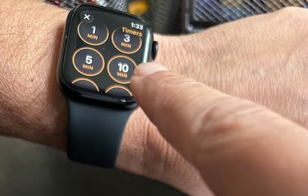An Apple Watch with a finger about to start a 10 minute timer